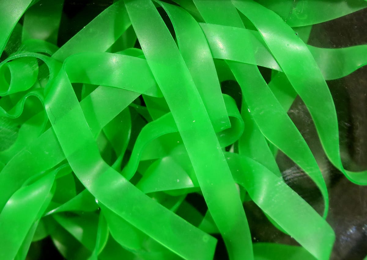 Neon green translucent Kiley's Nymph Skins ribbon strips, flexible latex-like material for fly tying nymph bodies