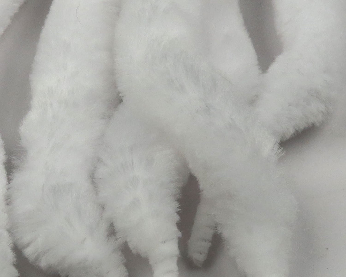 White fluffy synthetic Mini Dragon Tails, soft fur-like strips for fly tying, close-up texture