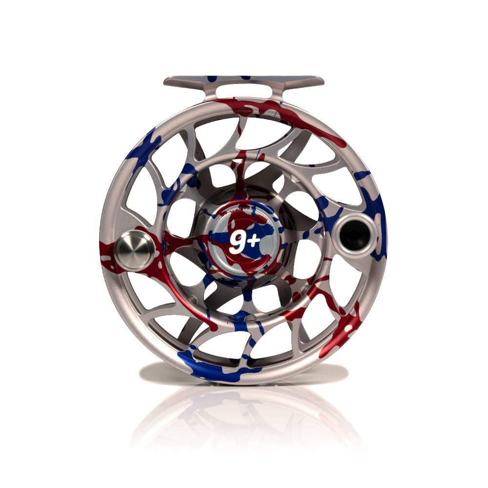 Silver anodized Hatch Iconic 9+ fly reel with red and blue USA splatter finish, large-arbor machined aluminum design