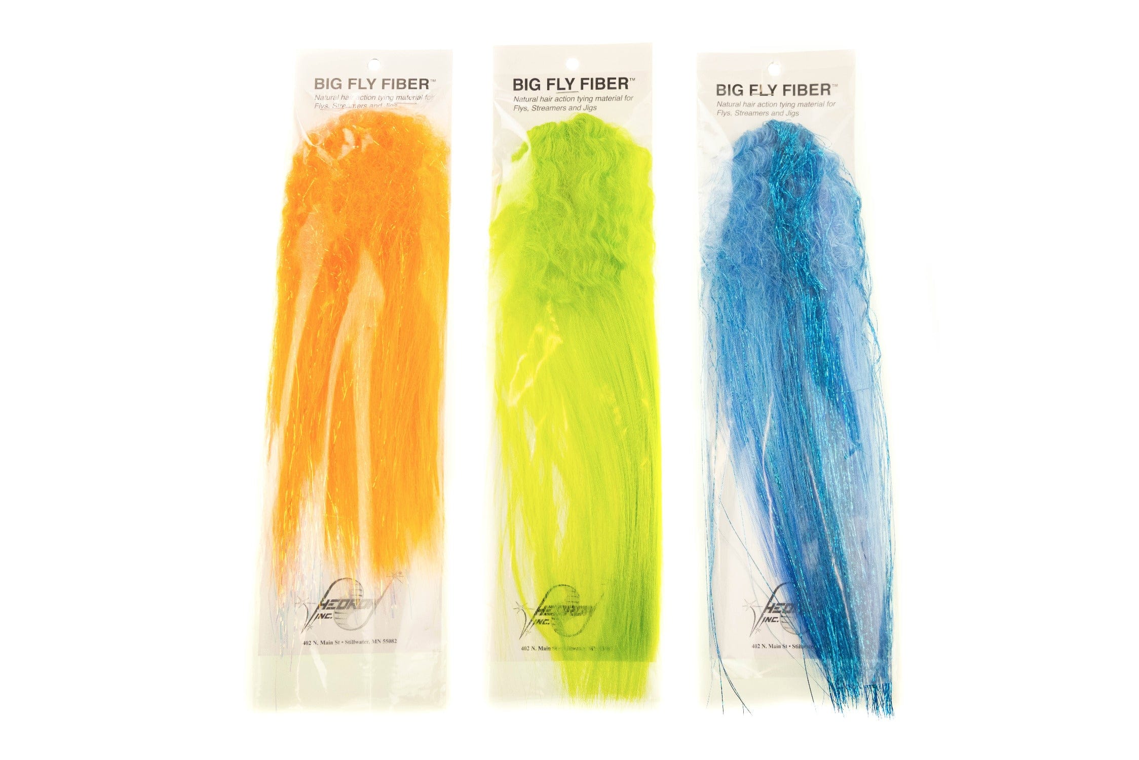 Three Hedron Big Fly Fiber packs of long curly synthetic fiber in orange, chartreuse and blue with shiny flash for fly tying