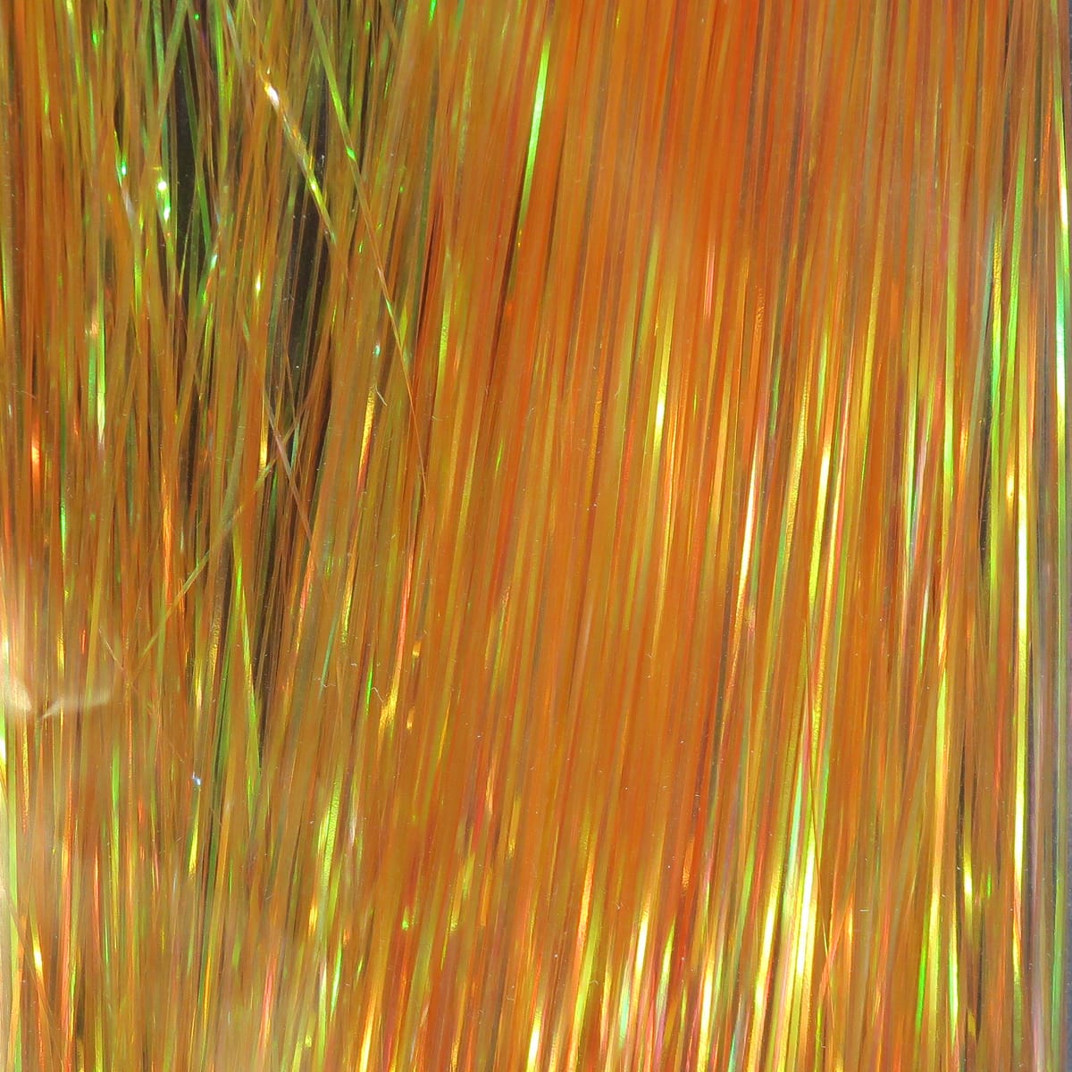Orange pearlescent Hedron Flashabou strands with iridescent green highlights, metallic synthetic tinsel for fly tying