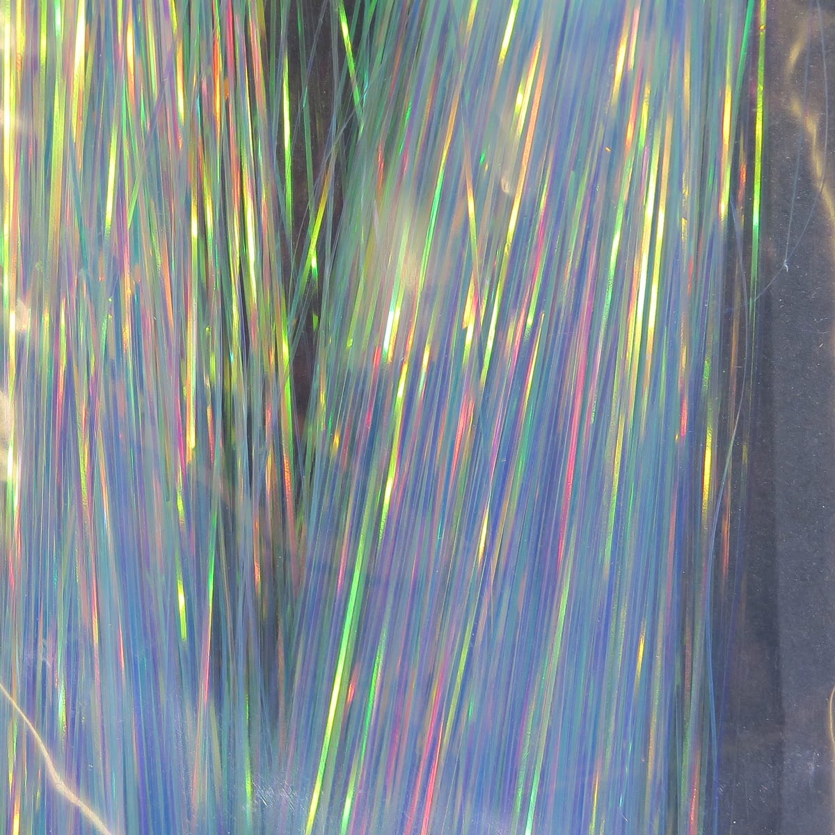 Iridescent pearl Hedron Flashabou strands in dyed holographic rainbow hues, thin reflective tinsel for fly tying