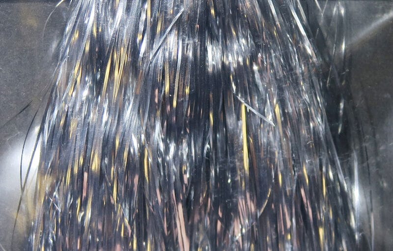 Silver Hedron Flashabou fly tying material with thin metallic tinsel strands and gold-reflective flashes