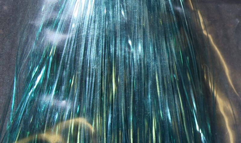 Teal iridescent Hedron Flashabou synthetic tinsel strands for fly tying, narrow reflective metallic fibers