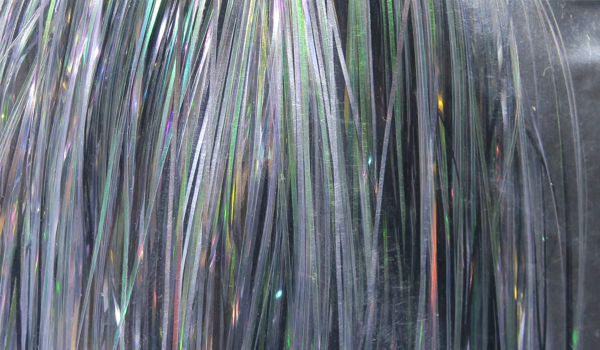 Hedron Flashabou holographic silver fly tying tinsel with thin iridescent reflective strips showing green and purple flash