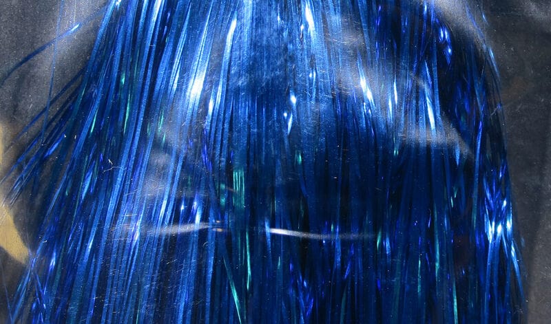 Metallic blue Hedron Flashabou tinsel strands with iridescent, reflective synthetic fibers for fly tying