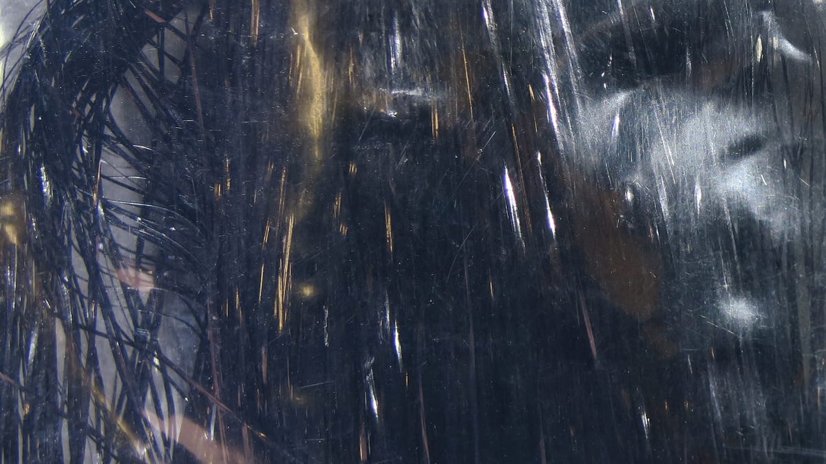 Dark navy metallic Flashabou tinsel strands with silver flash for fly tying