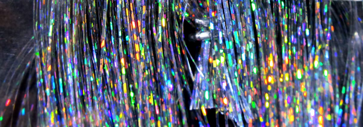 Hedron Flashabou silver tinsel strands with holographic rainbow sparkle, fine reflective fly tying material