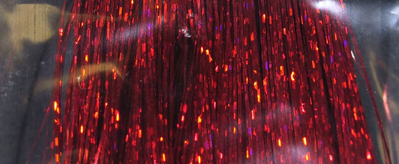 Hedron red holographic Flashabou strands, reflective metallic foil fibers with red-orange sparkles for fly tying