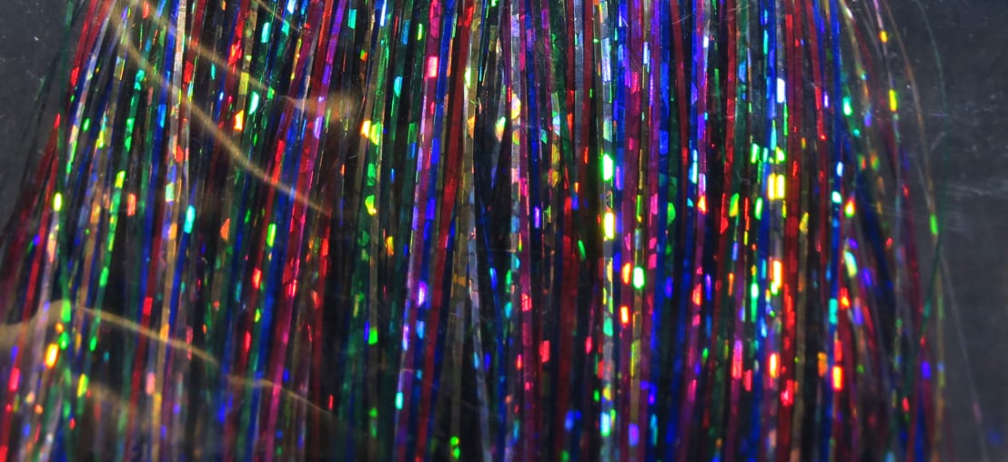 Hedron Flashabou holographic tinsel: thin iridescent strands in red, blue, green and purple for fly tying