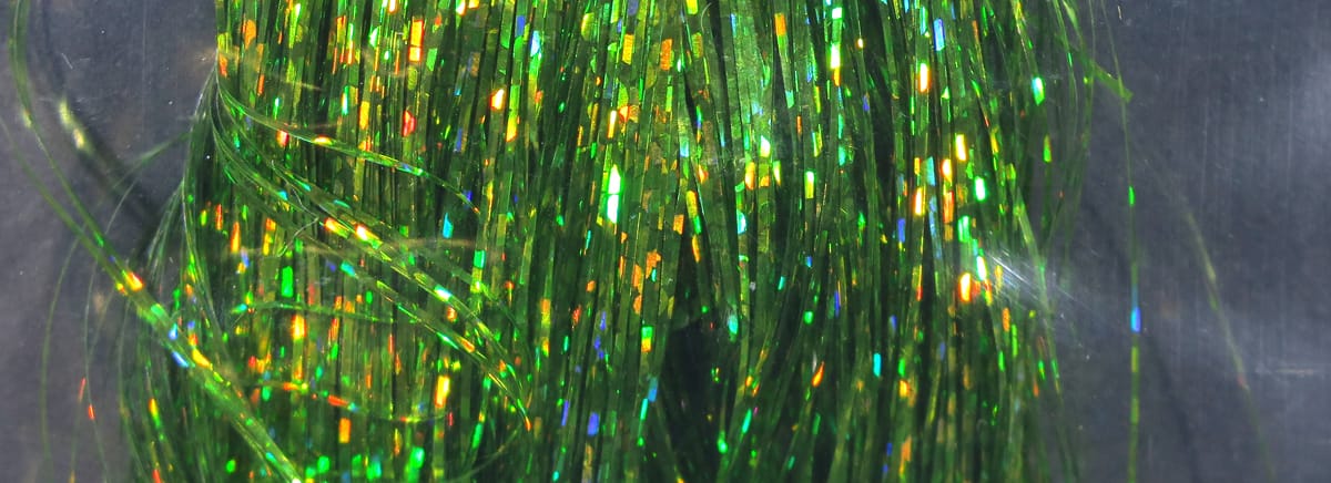 Green holographic Flashabou strands with iridescent gold, blue and orange flashes, thin reflective tinsel for fly tying