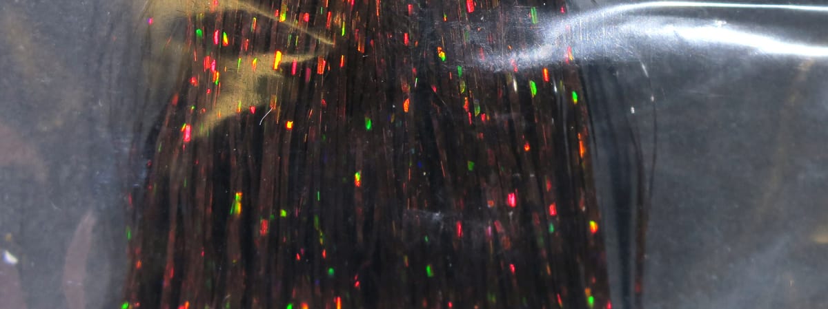 Black Hedron holographic Flashabou strands with red, green and gold reflective tinsel flecks for fly tying