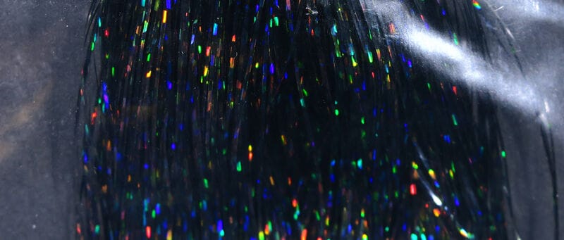 Hedron holographic Flashabou strands in black with rainbow reflective flakes, thin synthetic fly tying material