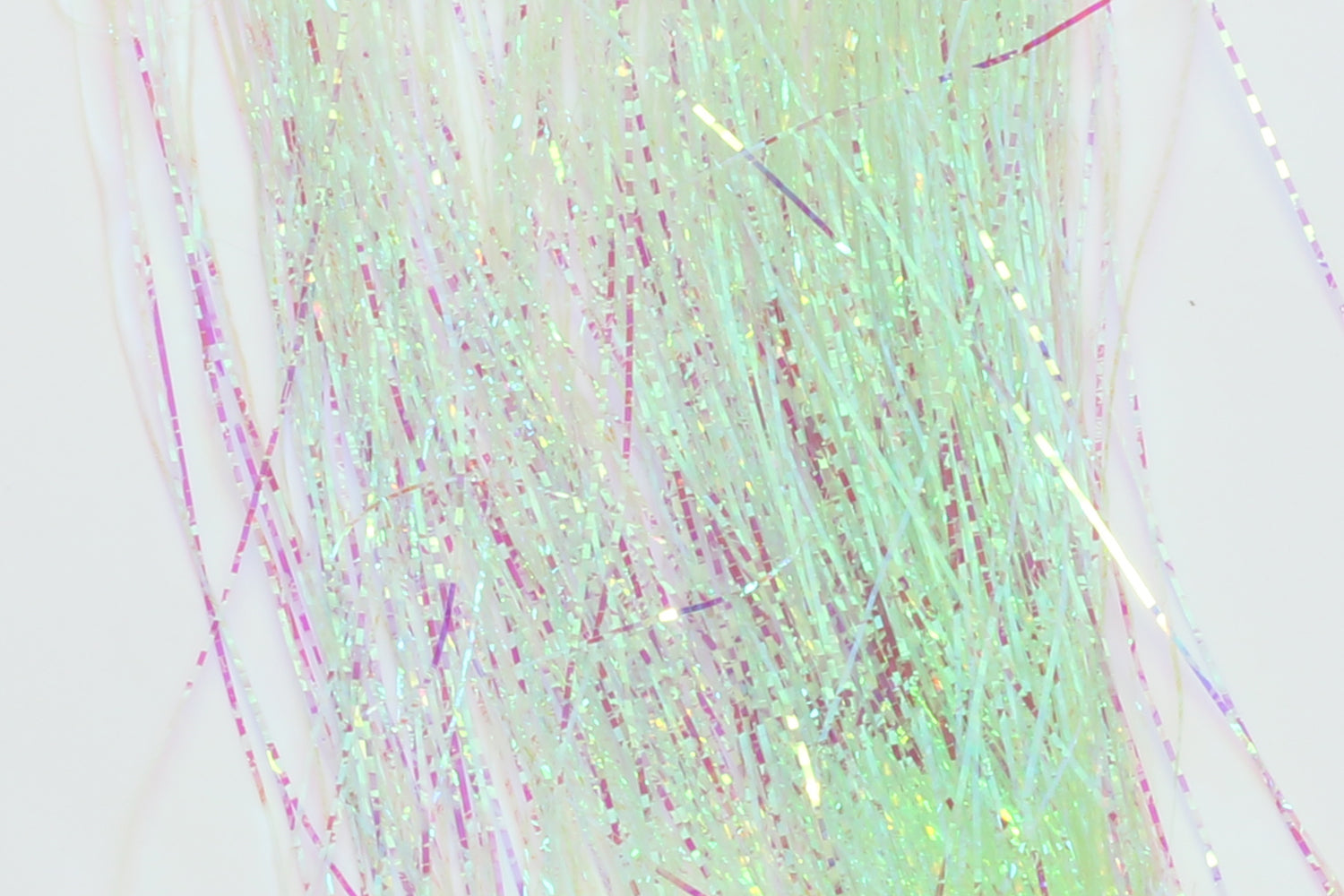 Hedron lateral scale holographic tinsel strands in iridescent pale green with pink highlights for fly tying