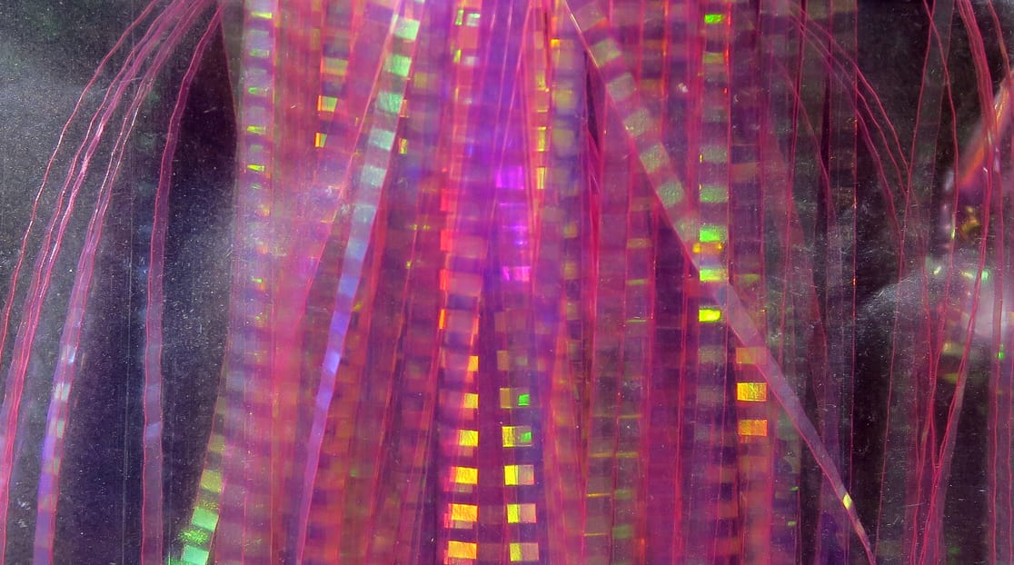 Iridescent pink-purple holographic lateral scale strips with square reflective pattern, translucent plastic fly tying