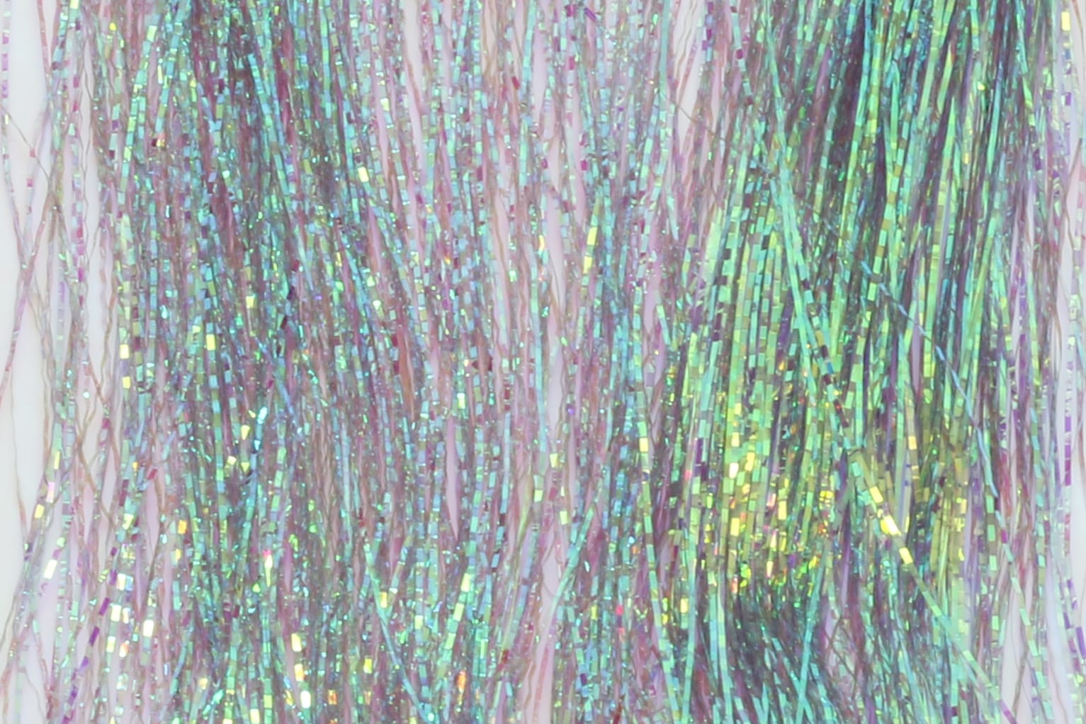 Iridescent pink and green holographic lateral scale tinsel strands for fly tying, thin metallic rectangular fibers