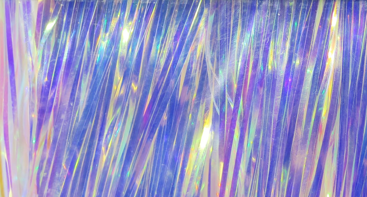 Iridescent pearlescent purple-blue Hedron Magnum Flashabou strands with holographic rainbow reflections for fly tying