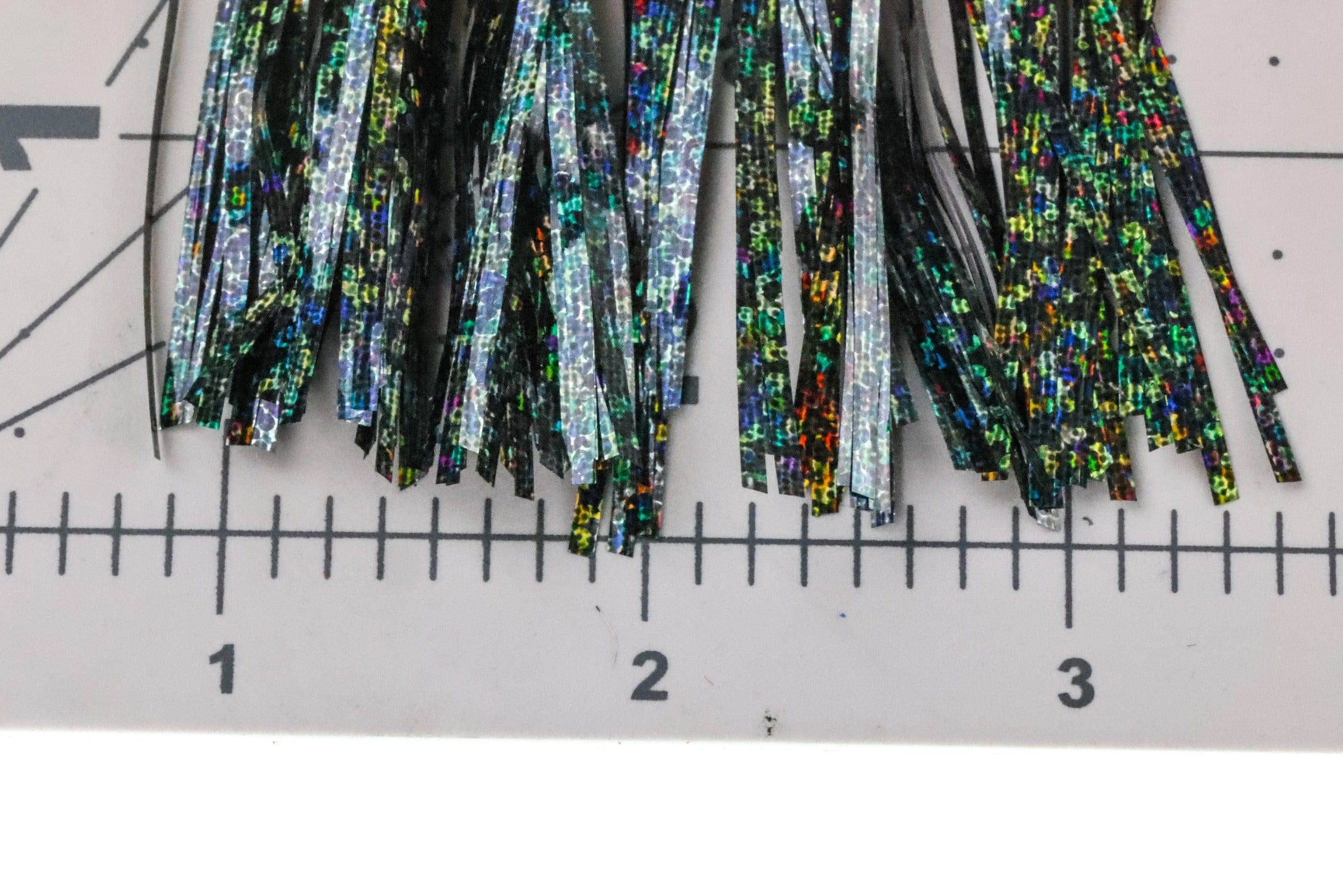 Hedron Saltwater Flashabou holographic tinsel strips, black-backed iridescent green, blue and orange flash for fly tying