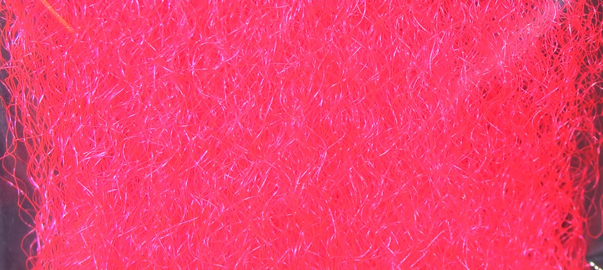 Bright neon pink Hedron strung fuzzy fiber with curly synthetic strands and iridescent shimmer for fly tying