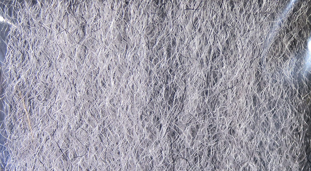 Silver-gray Hedron strung fuzzy fiber with fine curly synthetic filaments, fluffy textured fly tying material
