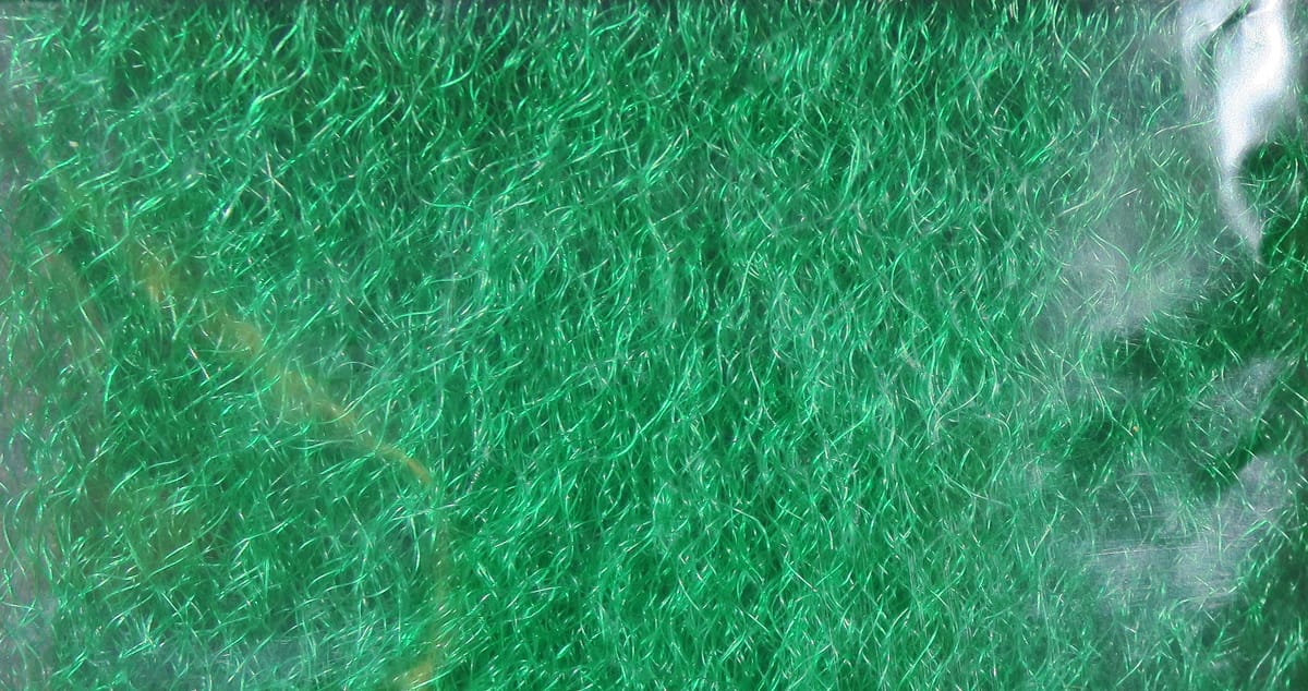 Bright green strung fuzzy fiber with shiny iridescent synthetic strands for fly tying