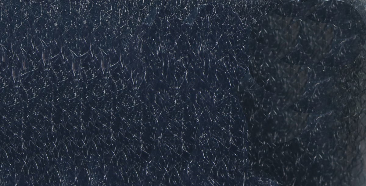 Dark navy strung fuzzy fiber with silver flash, dense fine synthetic hairs, soft textured material for fly tying