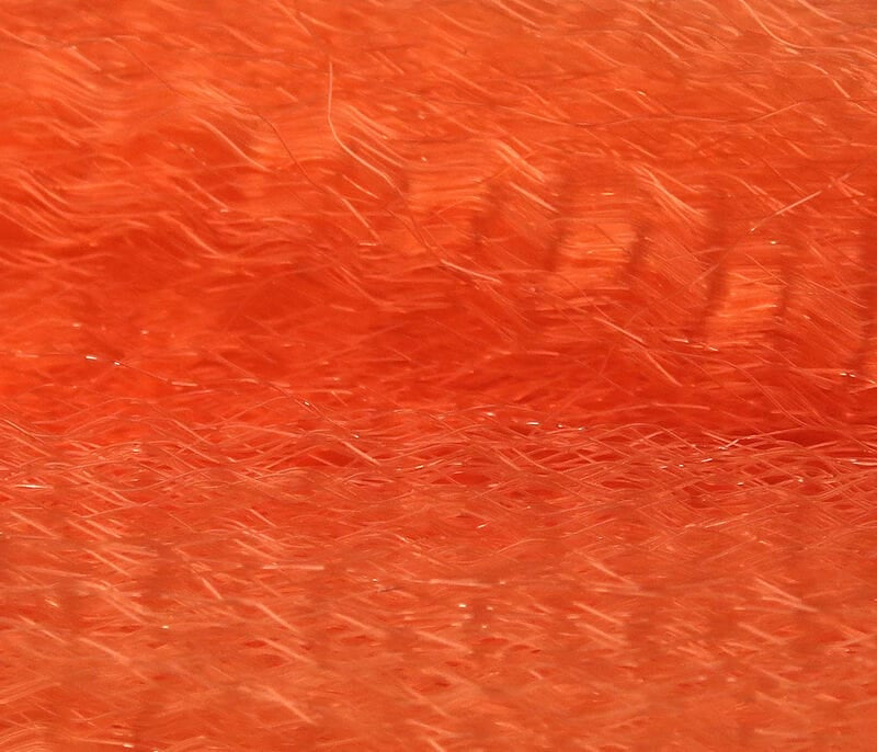 Bright orange synthetic fly tying hair, wispy long fibers with subtle iridescent flash, Hedron Unique Hair