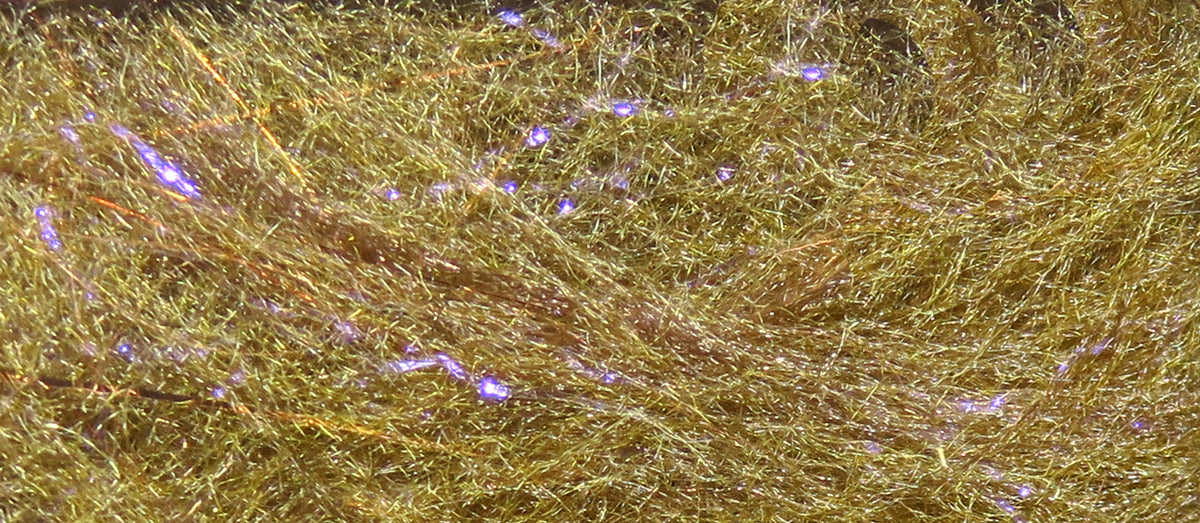 Golden-bronze synthetic dubbing fibers with fine hairy texture and purple iridescent flash, fly tying material