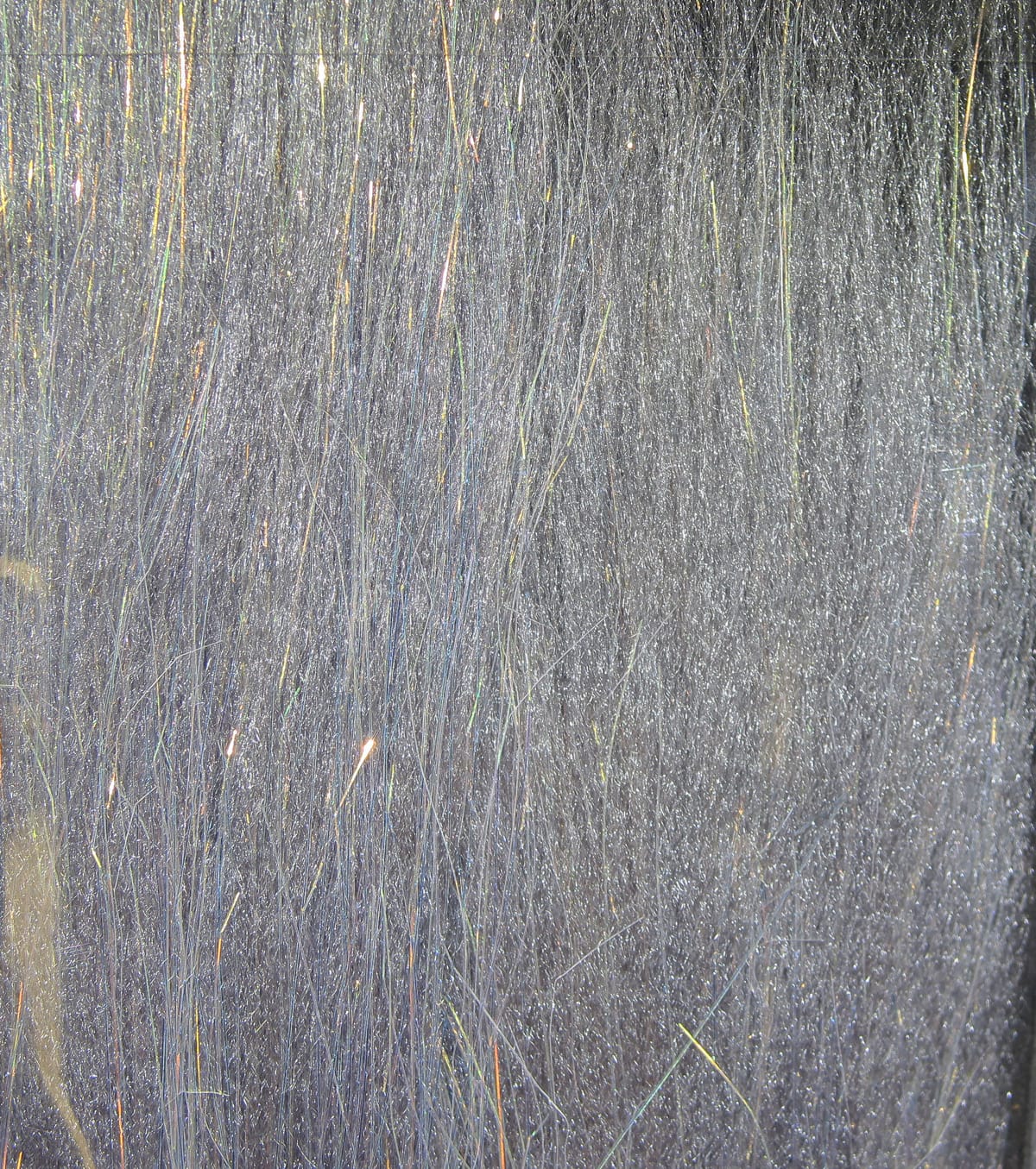 Silver-gray iridescent Angel Silk fibers with fine shimmering strands, translucent fly tying material