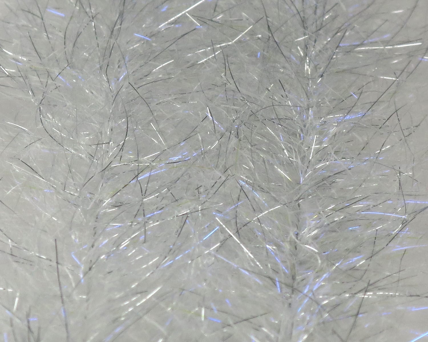 White iridescent synthetic baitfish brush fibers with thin silver and blue flash strands for fly tying