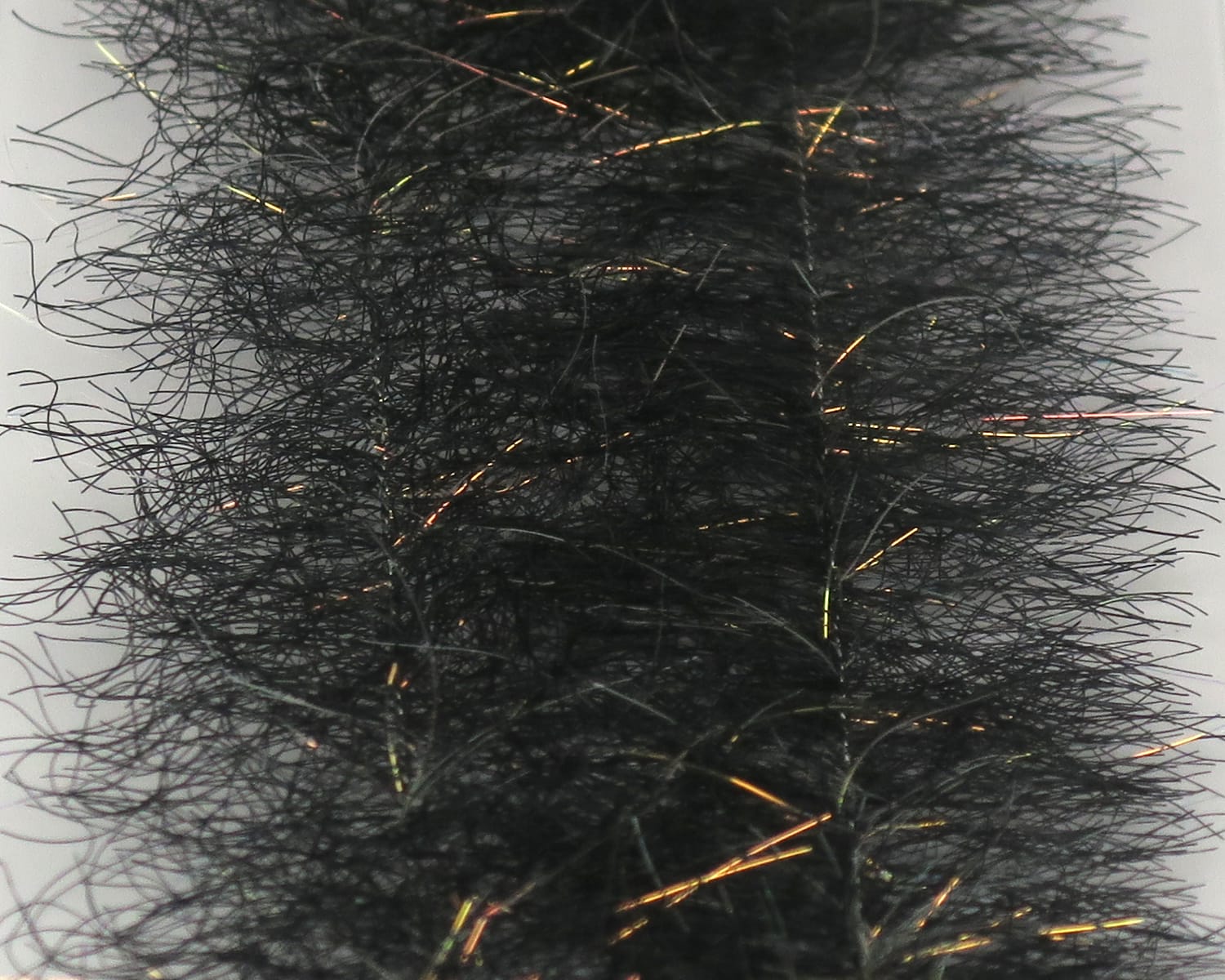 Black synthetic baitfish brush with dense fuzzy fibers and copper-green iridescent flash strands for fly tying