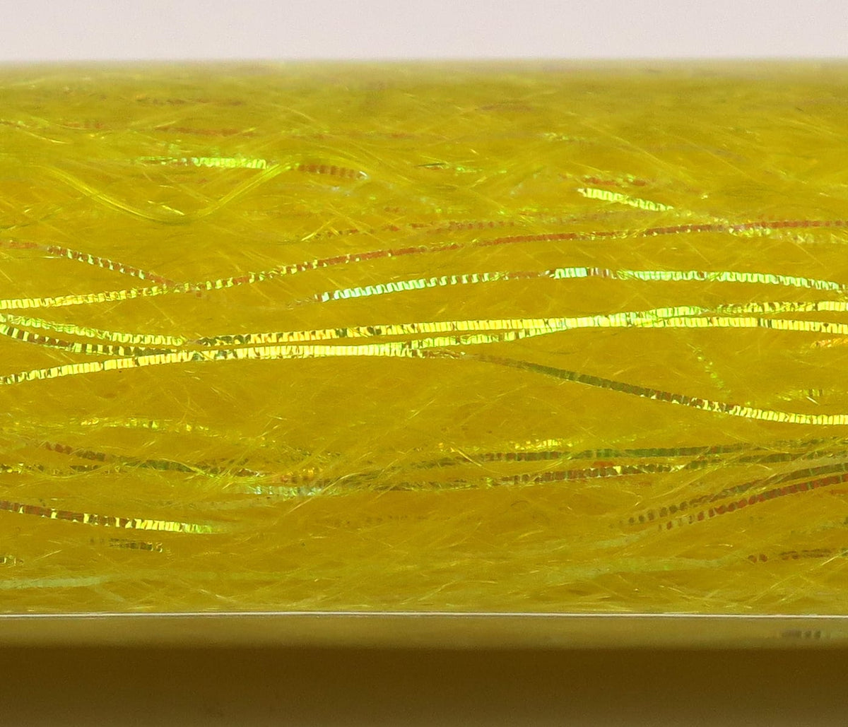 Bright chartreuse-yellow synthetic fly tying fibers with iridescent flash and thin slinky tinsel strands