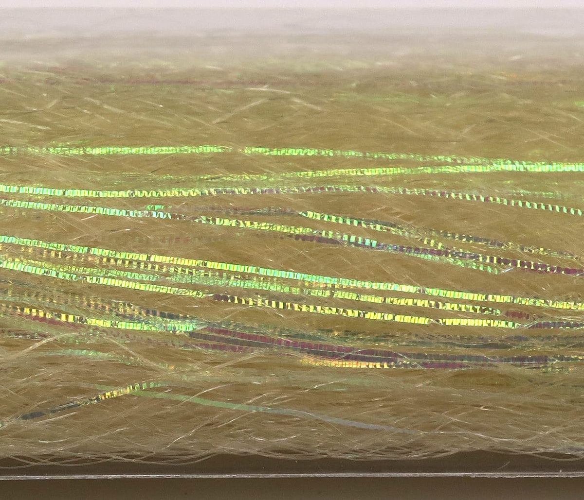Pale tan synthetic fibers threaded with thin iridescent green holographic strips, fly tying flash material