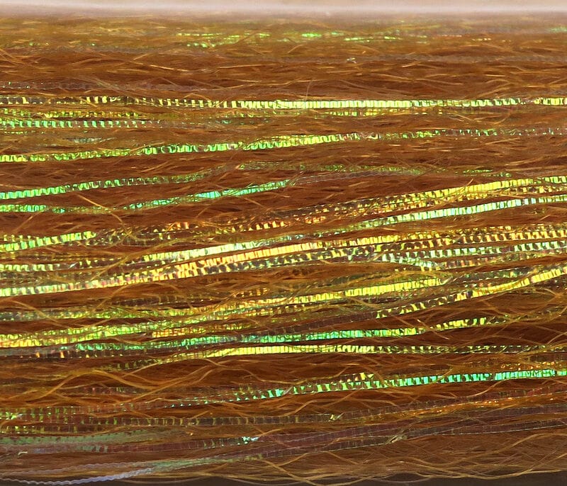 Golden-orange synthetic fibers with iridescent green-gold flash strips, slinky tinsel for fly tying