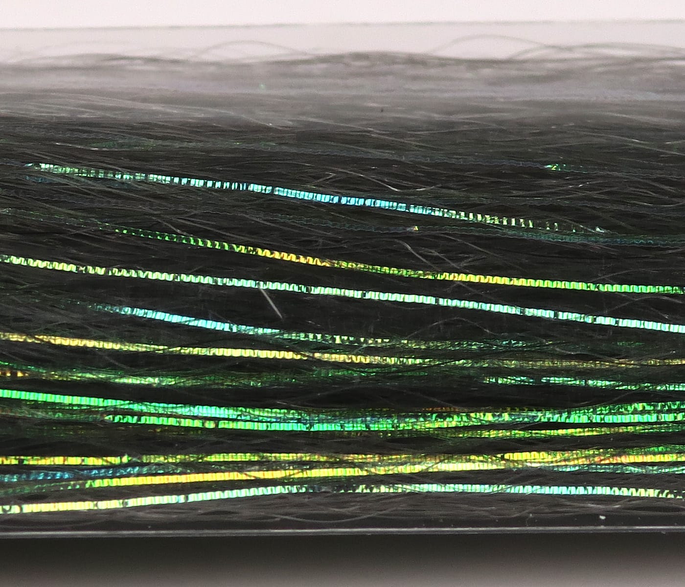 Dark green synthetic fibers with iridescent green and gold slinky flash strips for fly tying