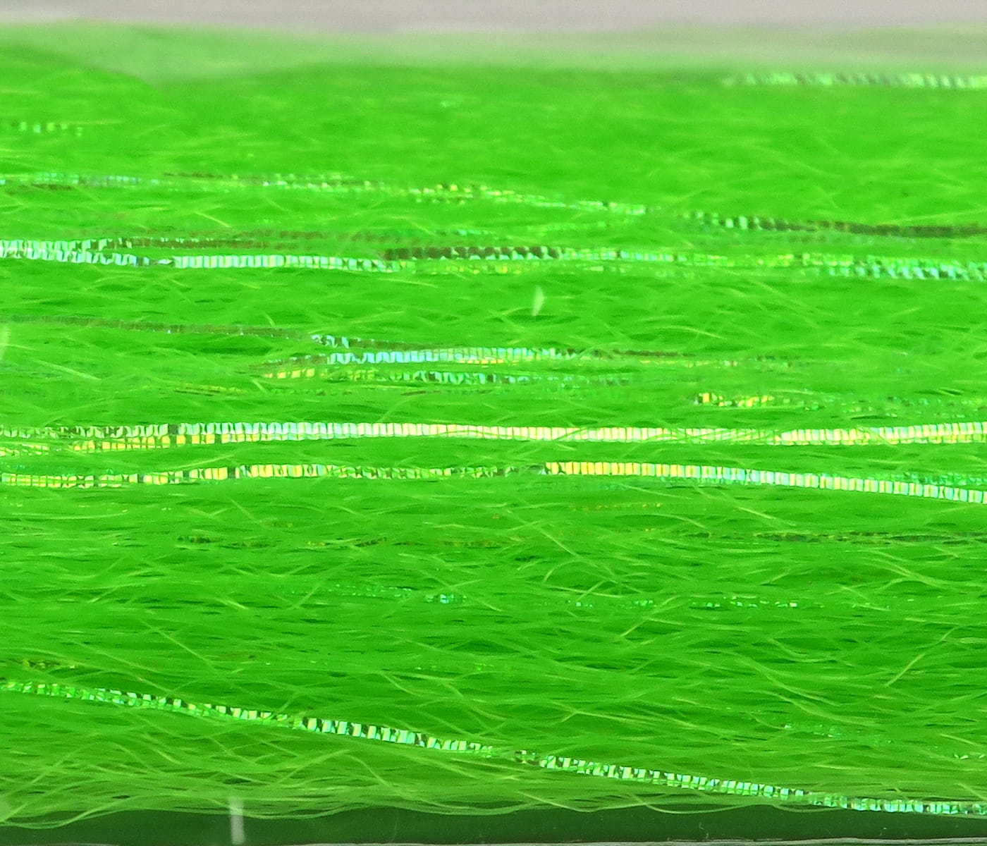 Chartreuse synthetic flash and slinky strands for fly tying with iridescent ribbon and fine fibrous material