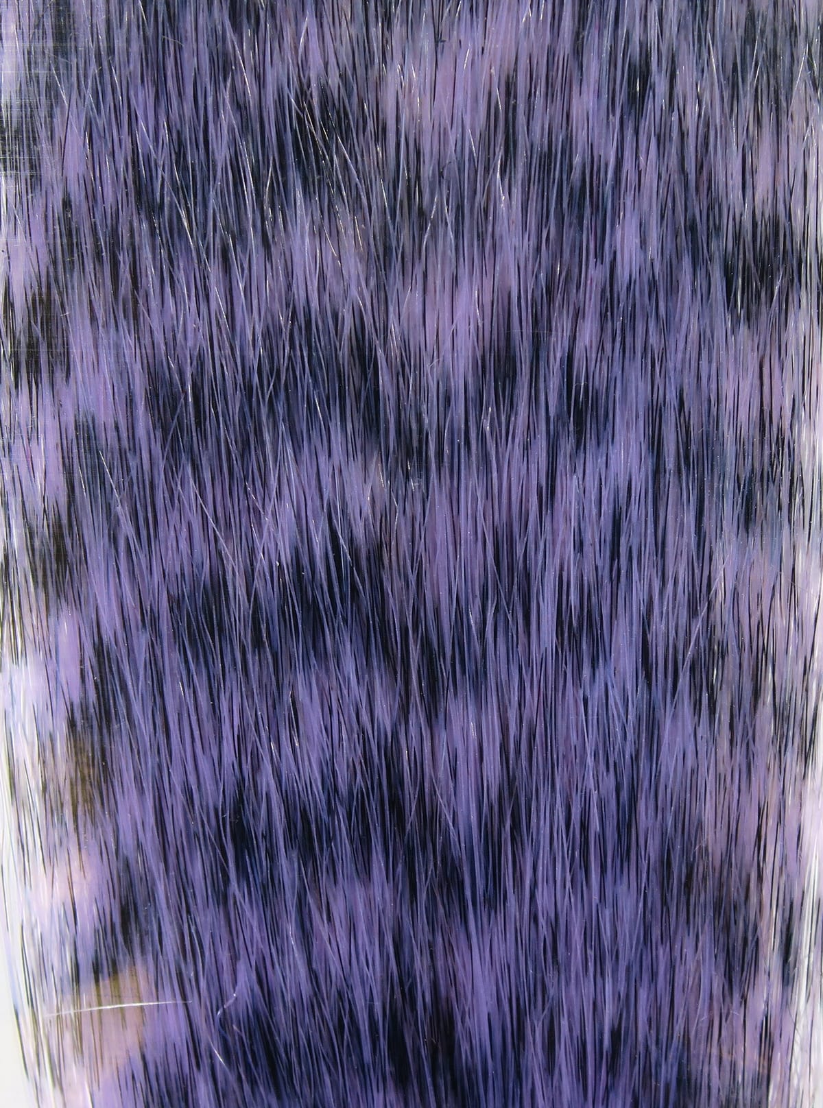 Purple and black grizzly fibre strands with mottled fur pattern, synthetic fly tying material