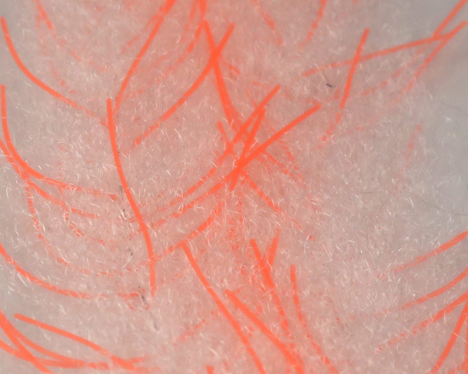 Pale pink synthetic fuzzy brush with bright orange rubbery strands, crustacean brush style for fly tying