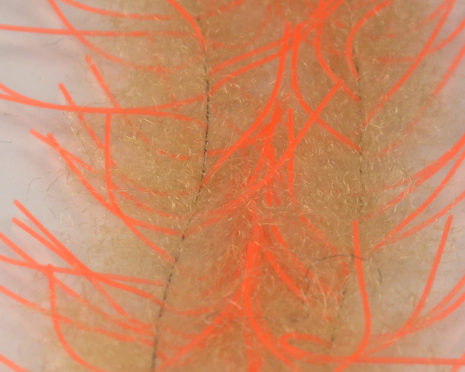 Tan synthetic fuzzy bristles with bright fluorescent orange rubber strands, Lively Legs crustacean brush for fly tying