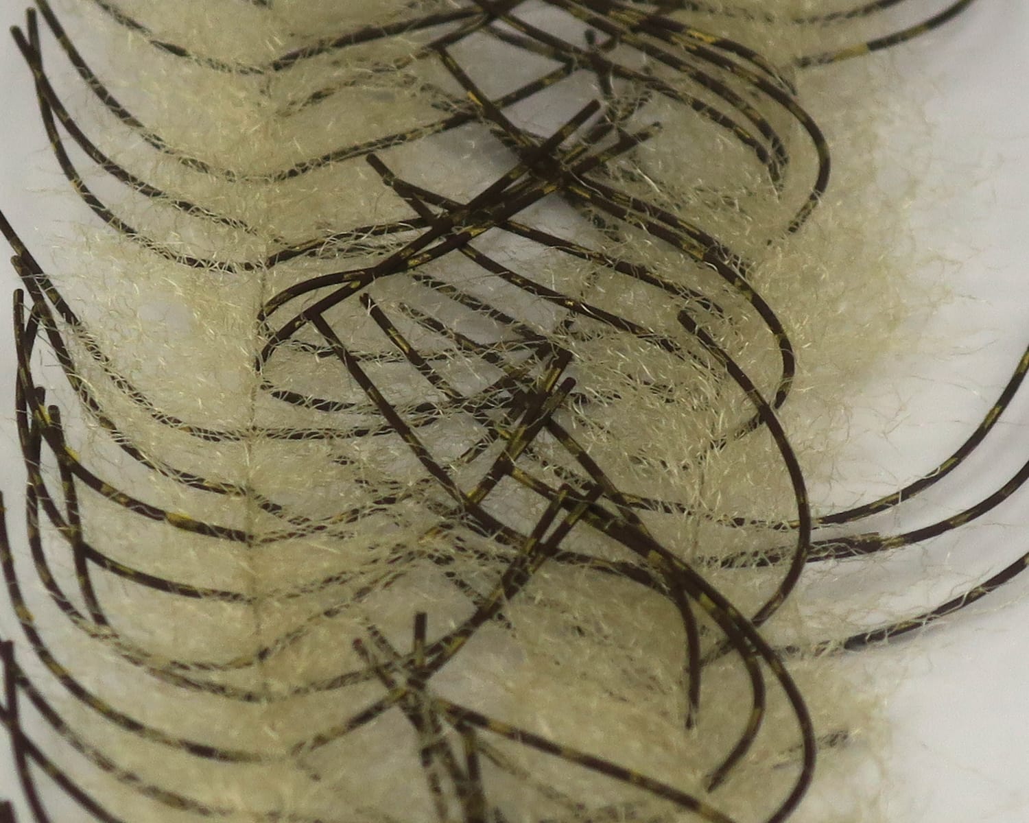 Cream synthetic crustacean brush with fuzzy beige fibers and dark brown rubber legs with yellow flecks for fly tying