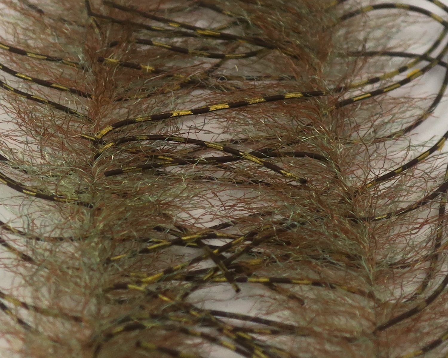 Olive-brown synthetic hairy brush with thin black and gold segmented rubber legs for fly tying