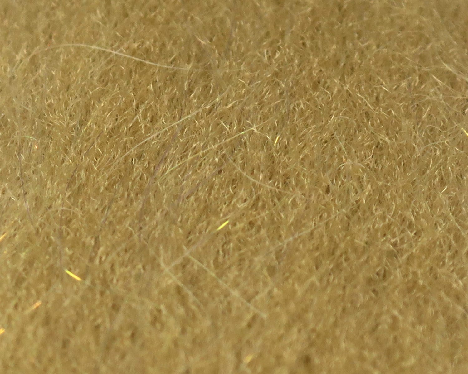 Golden tan sculpting flash fibre with fine fuzzy synthetic strands and subtle iridescent flash for fly tying