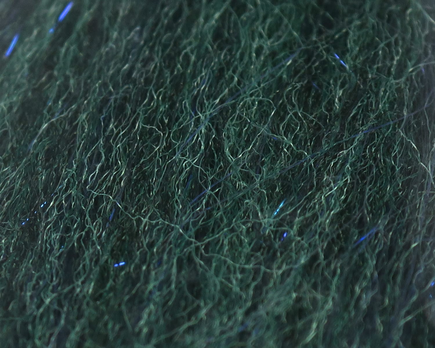 Dark emerald green sculpting flash fibre with fuzzy tangled synthetic strands and subtle blue reflective flash for fly tying