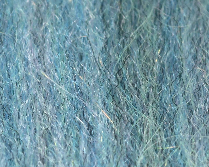Teal and aqua Sculpting Flash Fibre for fly tying, close-up of fine synthetic hairs with iridescent reflective strands