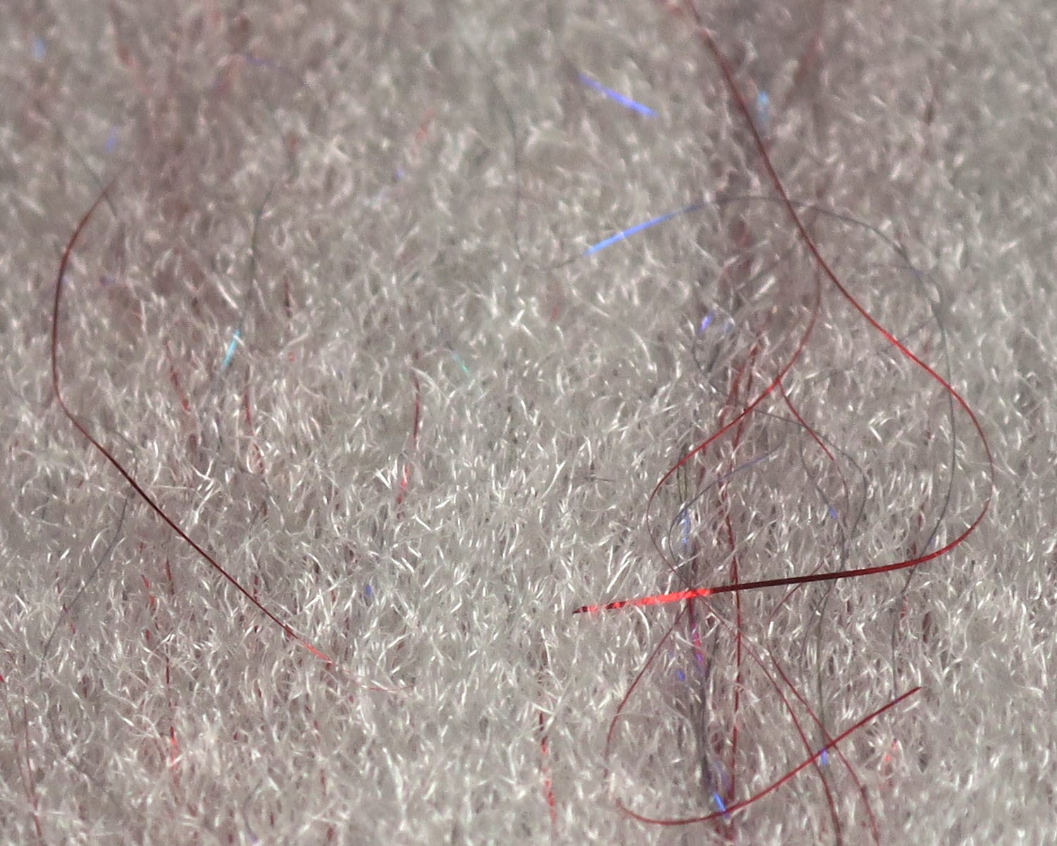 White sculpting flash fibre mat with thin red and blue iridescent strands for fly tying