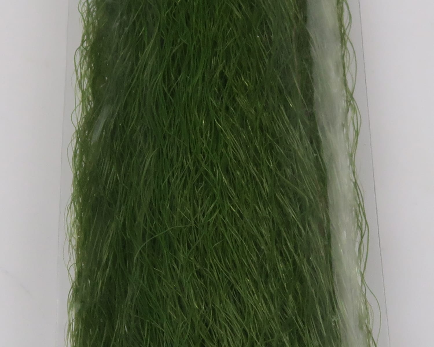 Olive green synthetic Slinky Fibre strands, wavy textured fly tying material in clear packaging