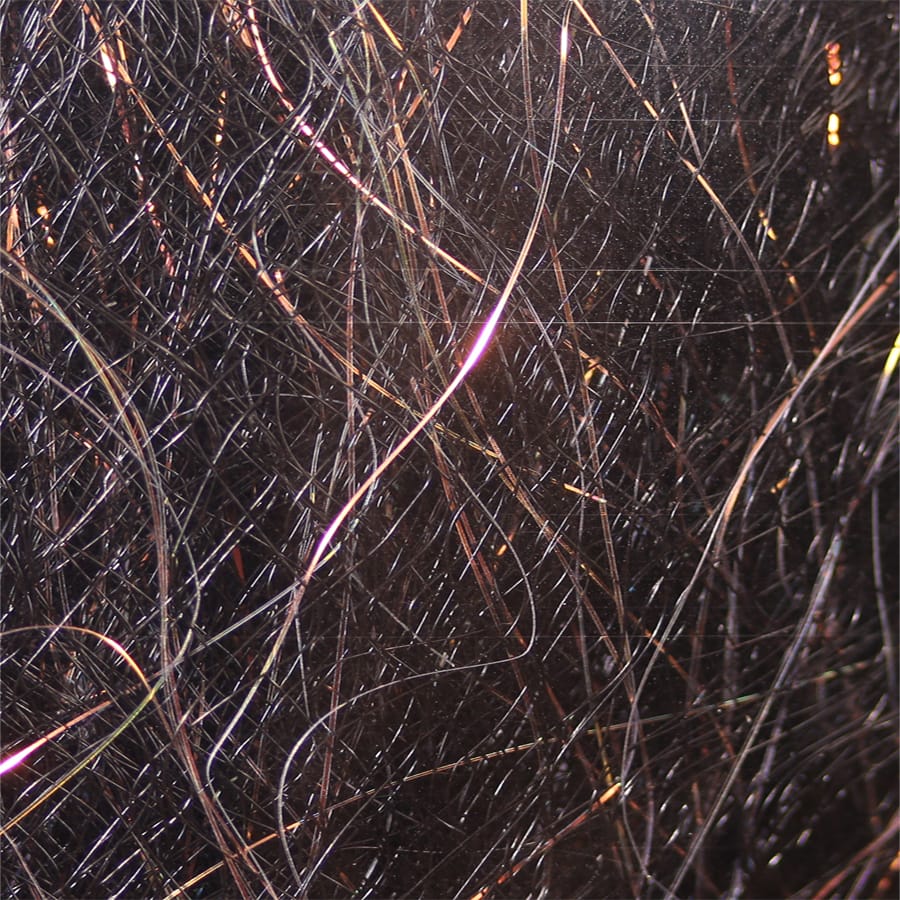 Black synthetic fly tying dubbing with fine dark fibers and coppery-pink iridescent flash strands, glossy wispy blend