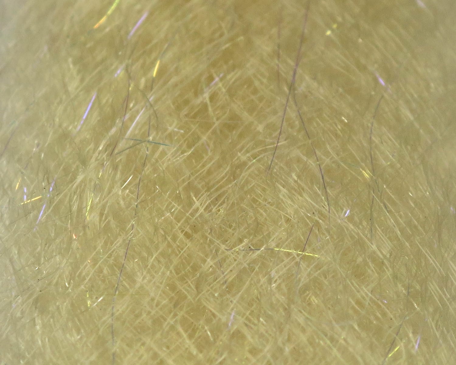 Pale tan synthetic fly tying dubbing with wispy fur fibers and thin iridescent UV strands