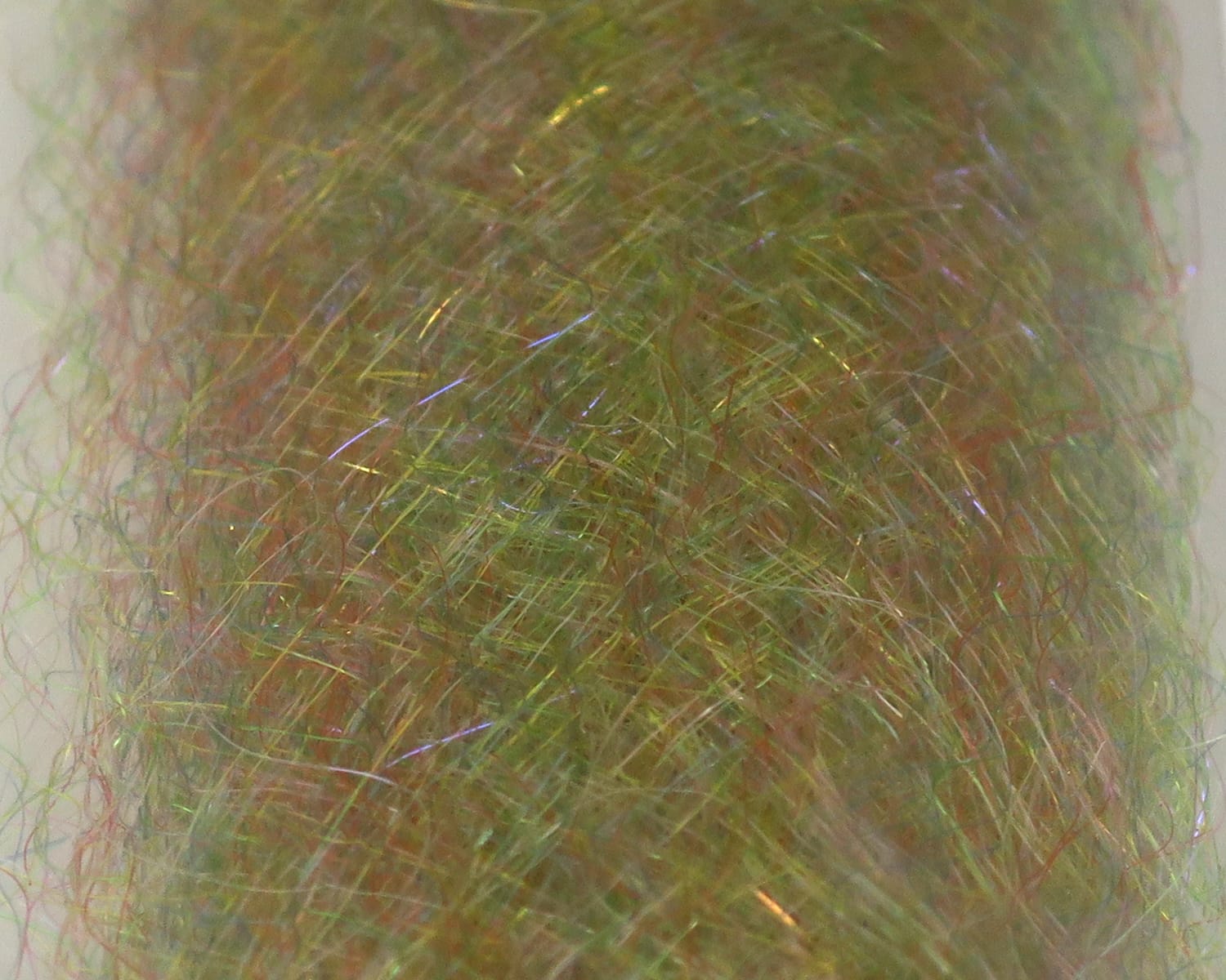 Olive-green iridescent synthetic fly-tying dubbing with fine wispy fibers and gold UV flash