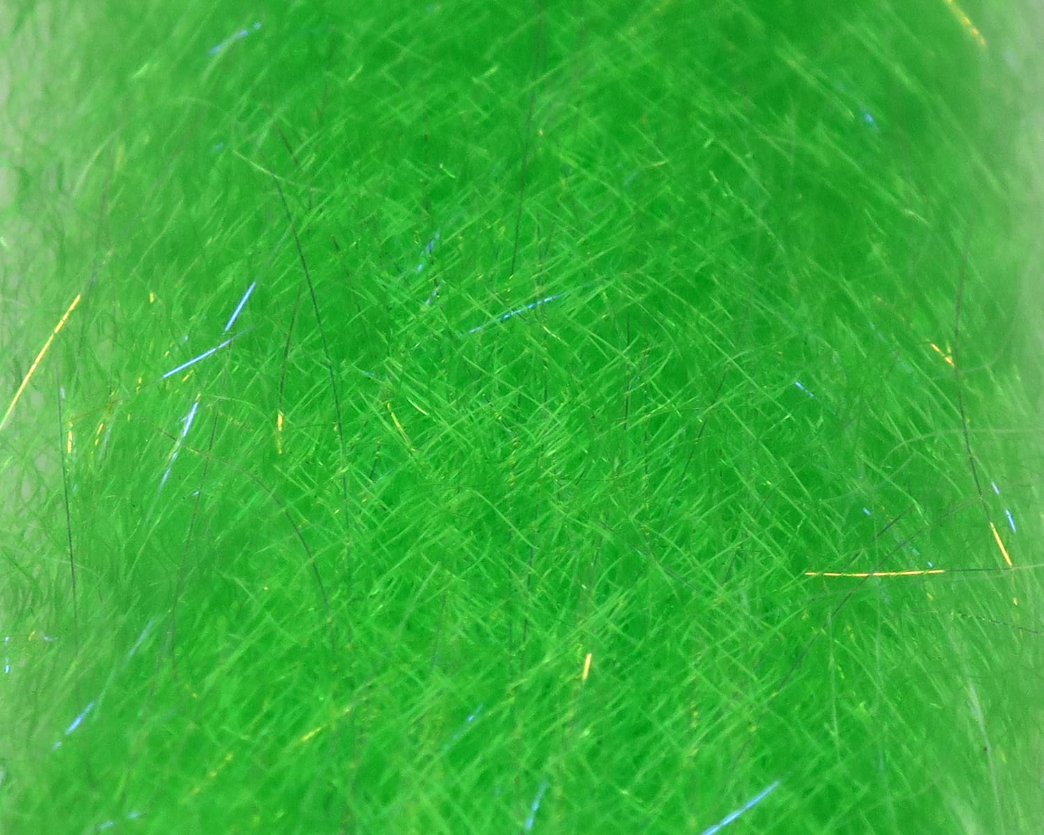 Neon green UV dubbing blend with fine synthetic fibers and blue and gold flash strands for fly tying
